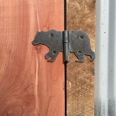 a metal latch on a wooden door with wood planks in the backround