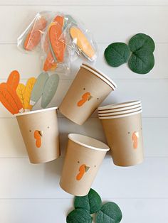 four paper cups with leaves on them