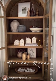 a book shelf filled with lots of books and vases on top of it's shelves