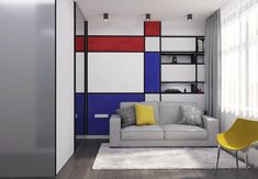 a living room with a couch, chair and bookshelf on the wall in front of it