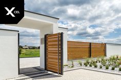 the entrance to a modern home with wooden gates