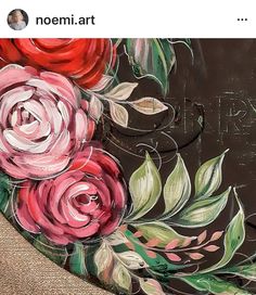 a painting of flowers painted on the side of a blackboard with writing underneath it