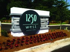 a large sign that reads 250 west in front of some flowers