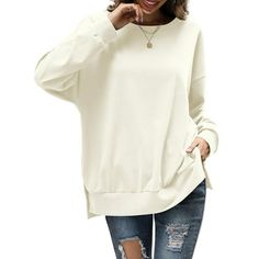 Step into effortless style with the Amoretu Women's Round Neck Sweatshirt. This oversized top, with its drop-shoulder design, exudes a relaxed yet chic vibe, perfect for the modern woman. The side split detail adds a contemporary touch, allowing for freedom of movement and a hint of flair. Crafted for comfort, the long sleeves provide warmth, making it an ideal choice for cooler days. Whether you're lounging at home or heading out for a casual rendezvous, this sweatshirt promises not only comfor Solid Color Plain Drop Shoulder Tops, Oversized Drop Shoulder Fall Tops, Oversized Plain Tops For Loungewear, Oversized Plain Top For Winter, Solid Color Drop Shoulder Tops, Oversized Drop Shoulder Winter Tops, Solid Color Drop Shoulder Tops For Fall, Oversized Solid Color Tops For Everyday, Oversized Plain Sweater