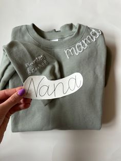 someone is holding up a t - shirt with the word nama written on it