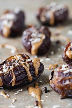 chocolate covered dates with nuts and coconut flakes on top, ready to be eaten