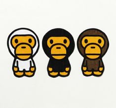 three monkey stickers are shown on a white surface, one is yellow and the other is black