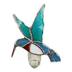 a stained glass humming bird night light on a white wall mounted holder with a blue, red and white design