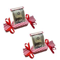 two bundles of money tied with red and white striped ribbon, sitting on top of each other