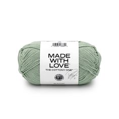 a ball of yarn with the words made with love in white and green on it