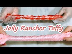 two hands are holding an object that looks like a rope and the words jolly rancher taffy