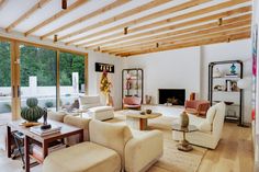 a living room filled with furniture and a fire place in the middle of a room