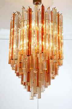 a chandelier made out of glass tubes hanging from the ceiling