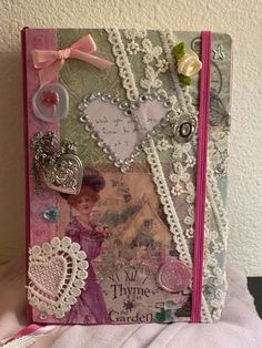 an altered book with lace and buttons on it