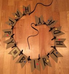 a birthday decoration made out of cardboard on a wooden floor with the words happy birthday written in large letters