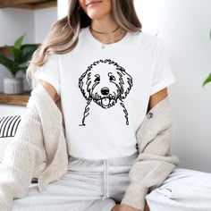 a woman wearing a white shirt with a black dog on it