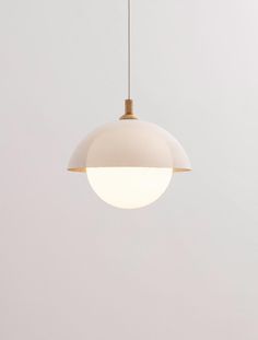 a white light hanging from a ceiling in a room