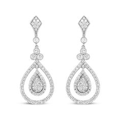 Let the sparkle of diamonds enhance your every look! Glimmering prong-set round diamonds adorn polished 18k white gold, giving you a stunning look of sophistication. These diamonds total 1 1/4 cttw with an approximate F-G Color and VS1-VS2 Clarity. The silhouette features an intricate upper dangle set with diamonds clusters above a single round diamond encases in a secure bezel setting with milgrain detail. Beginning the lower dangle is a trio of round white diamonds that signify the past, present, and future, which are also showcases in bezel settings with milgrain ornamentation. A cluster of round, prong-set diamonds form a teardrop silhouette haloed by additional round, prong-set diamonds. A metal framework prong-set with round diamonds adds a second halo to this centerpiece that captur Classic White Gold Diamond Chandelier Earrings, Classic Diamond Chandelier Earrings With Brilliant Cut, Platinum Diamond Drop Earrings With Pave Setting, Diamond Chandelier Earrings With Brilliant Cut For Anniversary, Anniversary Diamond Chandelier Earrings With Brilliant Cut, Dazzling Diamond White Drop Earrings, White Gold Pear-shaped Diamond Chandelier Earrings, White Gold Diamond Chandelier Earrings Pear-shaped, Diamond White Brilliant Cut Drop Bridal Earrings