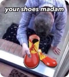 the man is trying to put his shoes on