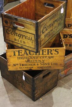 three wooden crates stacked on top of each other with labels attached to the lids and sides