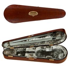 an open wooden case with silver linings on the inside and in it's side