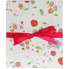 a white card with red ribbon and flowers on the front is decorated with pink ribbons