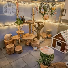 an indoor area with several wooden tables and stools made out of tree stumps