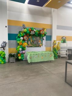 the balloon arch is decorated with animals and zebras for an animal themed birthday party