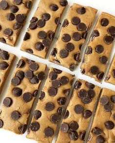 chocolate chip cookie bars cut into squares on a white surface