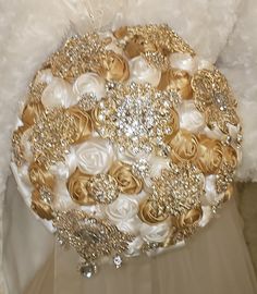 a bridal bouquet with gold and white flowers