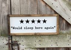 a sign that says, would sleep here again? on the side of a barn door