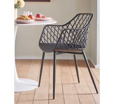 a white table and chair sitting next to each other on top of a hard wood floor