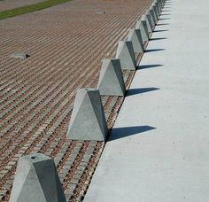 several cement cones are lined up on the ground