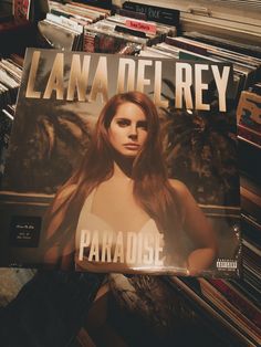 the cover of lana deirey's paradise album is shown in front of stacks of records