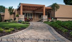 a brick walkway leads to the front entrance of a home