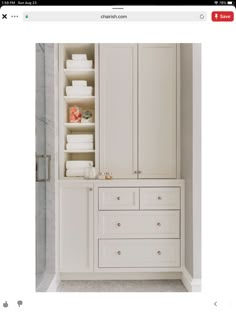 an image of a white closet with drawers and shelves on the bottom shelf in front of it