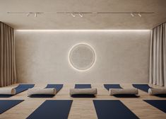 there is a yoga room with blue mats on the floor