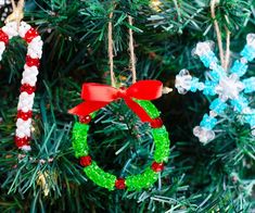 christmas ornaments hanging from a tree with snowflakes and candy canes on them