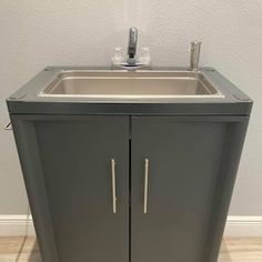 a bathroom sink sitting under a mirror next to a wall