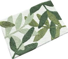 a green rug with leaves on it