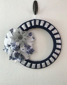 a blue and white wreath hanging on the wall