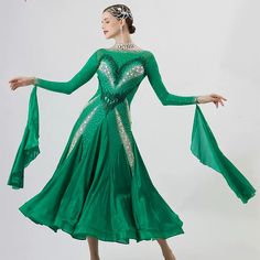 a woman in a green dress is dancing