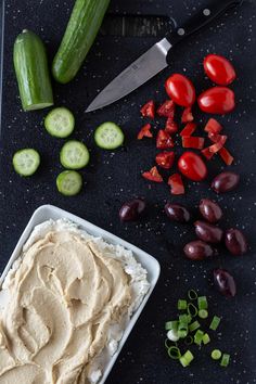 the hummus and cucumbers are ready to be cut into bite - sized pieces