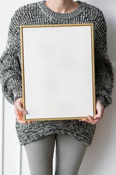 a woman holding an empty white board in her hands