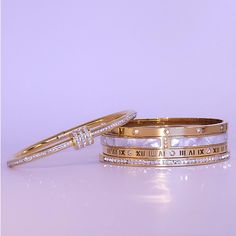 Elevate your style with this exquisite Gold-Plated Roman Numeral Gemstone Bracelet. The luxurious gold plating combined with shimmering gemstones offers a sophisticated and timeless design that's perfect for any occasion. This bracelet features an intricate Roman numeral engraving, symbolizing a classic yet modern touch. Whether it's a gift for someone special or a treat for yourself, this bracelet effortlessly adds a touch of elegance to any outfit. Its sleek and slim design makes it comfortable for daily wear, while its sparkling gemstones ensure you stand out in a crowd. Why Choose Our Gold-Plated Roman Numeral Gemstone Bracelet: Premium Quality: Made from durable materials with a rich gold plating, ensuring longevity and shine. Versatile Design: Perfect for both formal events and casua Bracelet Elegant, Bangles For Women, Bangles Style, Roman Numeral, Bracelet Clasps, Roman Numerals, Slim Design, Jewelry Lover, Gemstone Bracelet