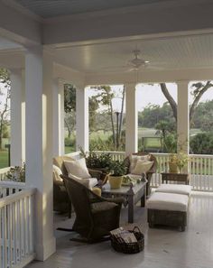 the porch is covered with wicker furniture