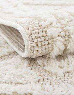 a close up view of a white rug