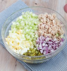 a bowl filled with chopped vegetables on top of a table