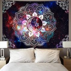 a large tapestry hanging on the wall above a bed