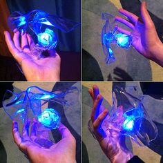 four pictures of hands holding an object with blue lights